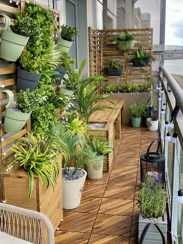 Stylish Edinburgh balcony with planters, lush greenery, and wooden decking